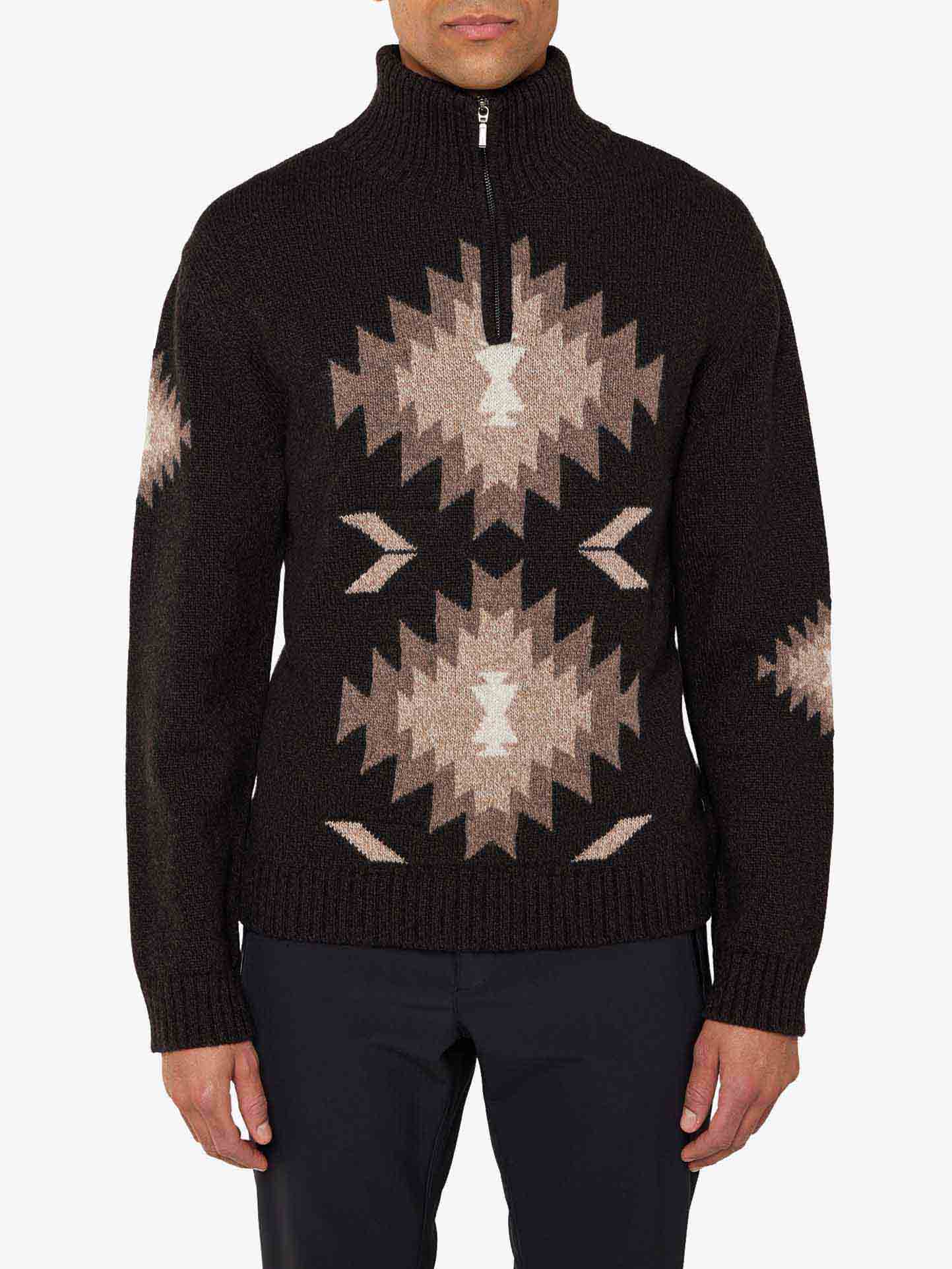 We Norwegians_FW25_Men | Model is wearing the Hovden sweater | Black in color with a striking jacquard pattern inspired by the Norwegian Sámi culture | Front view against a white background