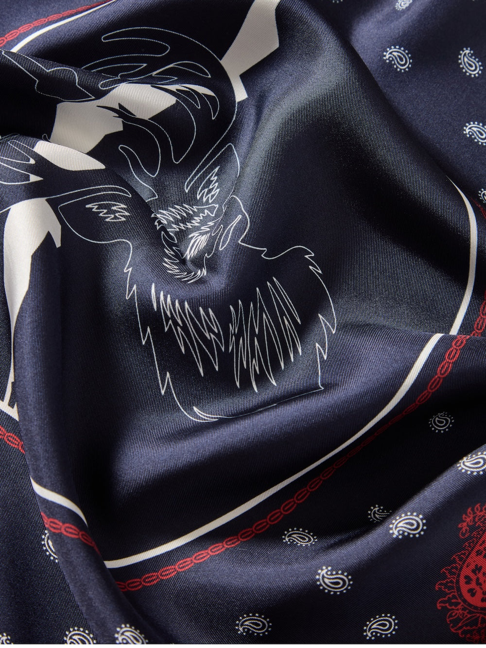 We Norwegians | FW25 | Western silk scarf_Navy blue | Printed with paisley patterns and a center stag motif | Photograph shows the details of the fabric and print