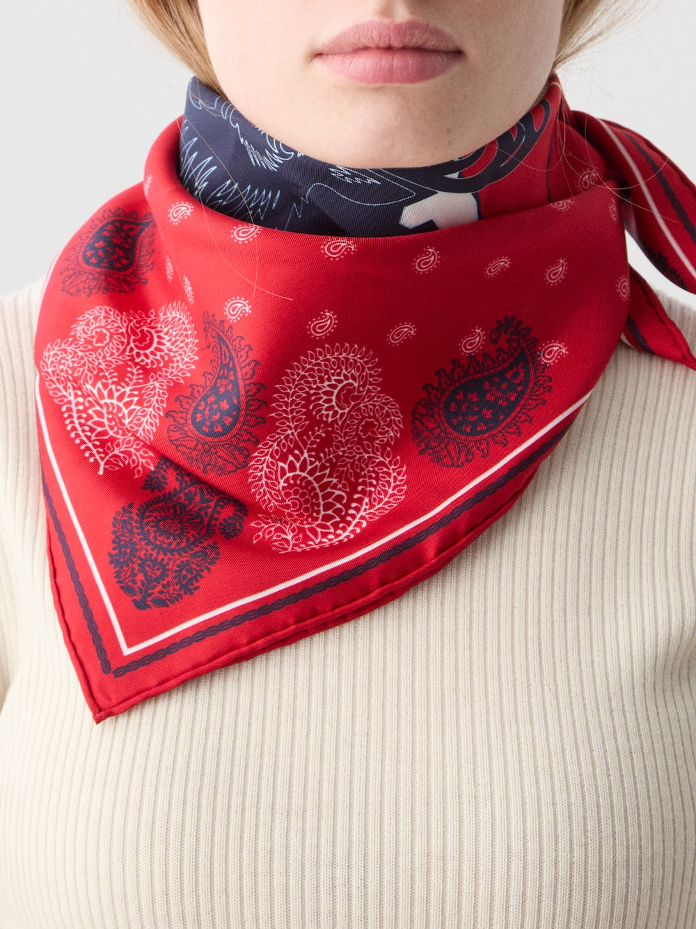We Norwegians | FW25 | A female model is wearing the Western silk scarf_Red | Printed with paisley patterns and a center stag motif