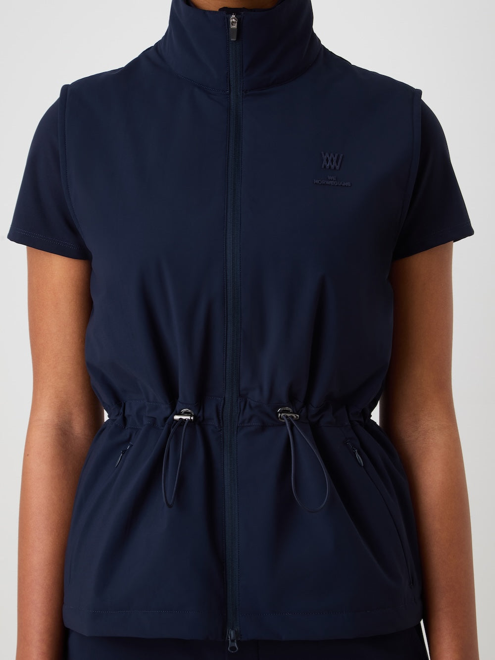Navy blue vest with a brand logo on a light background