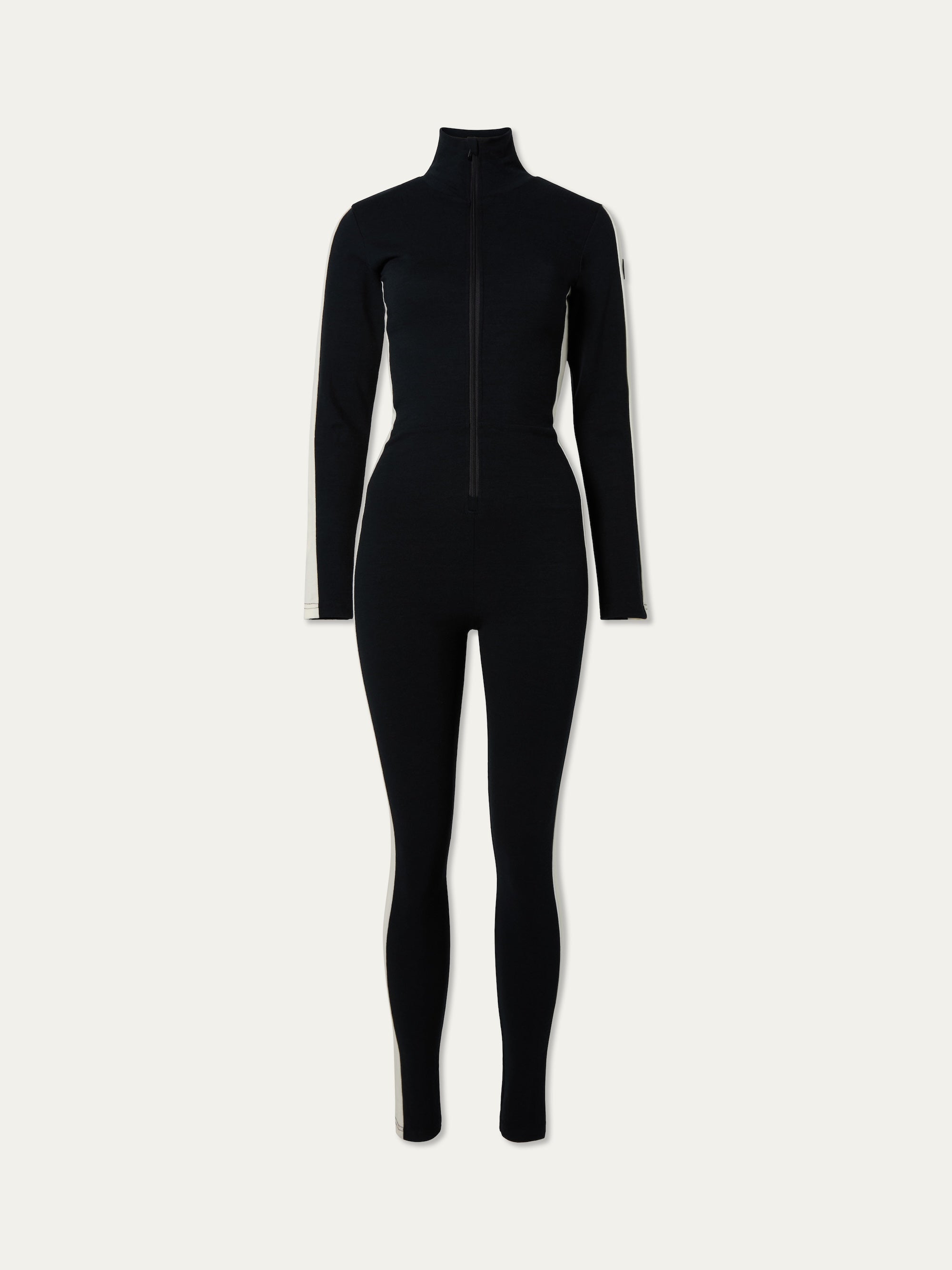 We Norwegians | FW25 | Womens Voss Jumpsuit_Black | A piqué knit jumpsuit with a front zipper opening, stand collar, white panels on the sleeves with subtle branding | Shot against an off-white background