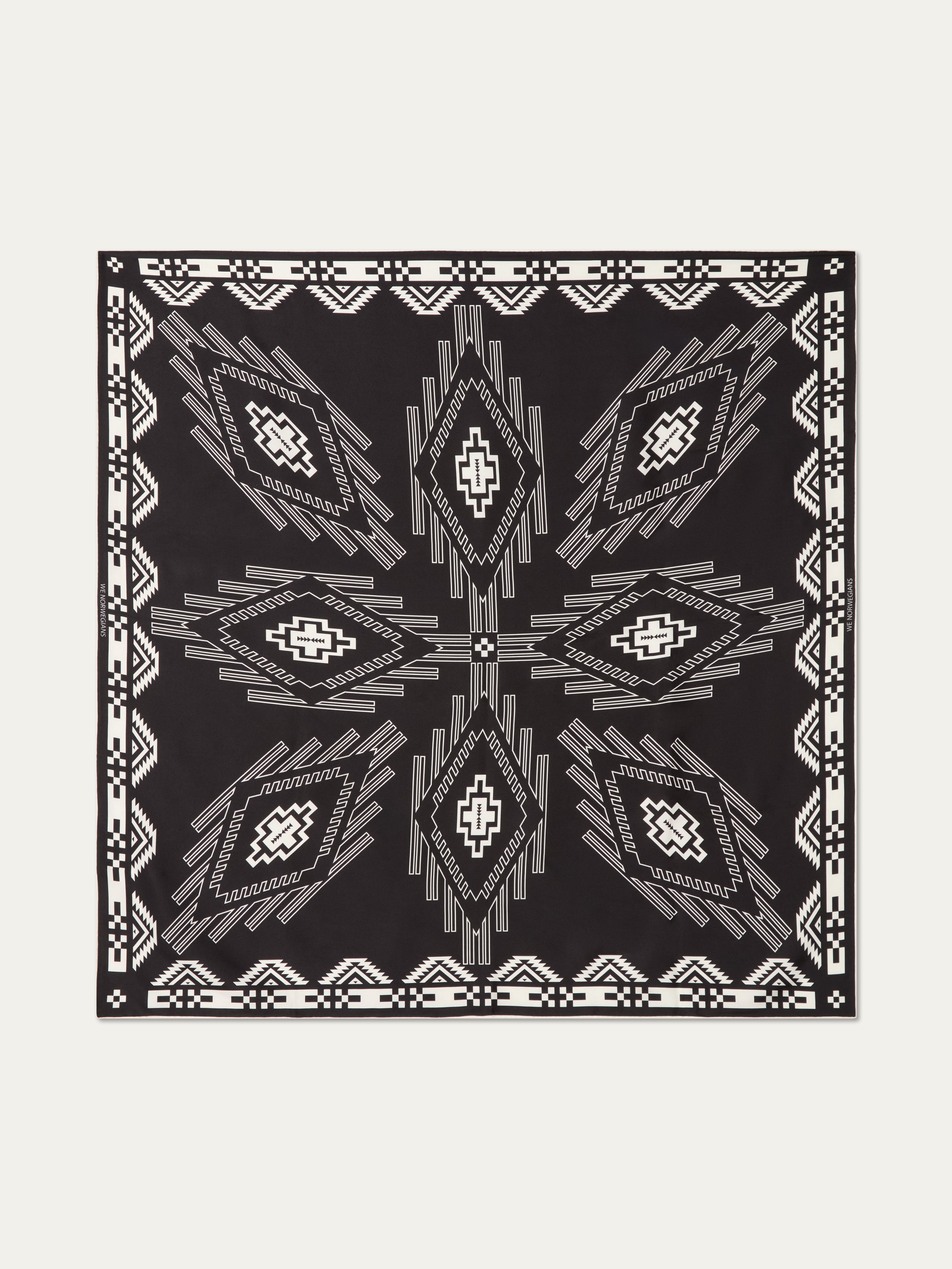 We Norwegians | FW25 | Pioneer Silk Scarf_Black | Scarf with printed motifs inspired by Indigenous American art | Shot against an off-white background