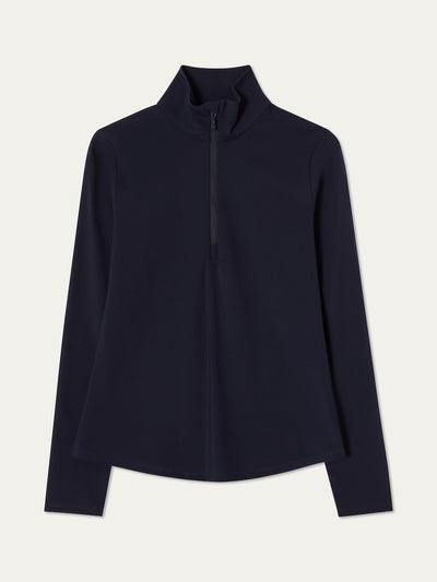 Navy blue long-sleeve top with a high collar on an off white background