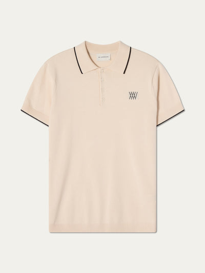 Beige polo shirt with black trim on an off white background